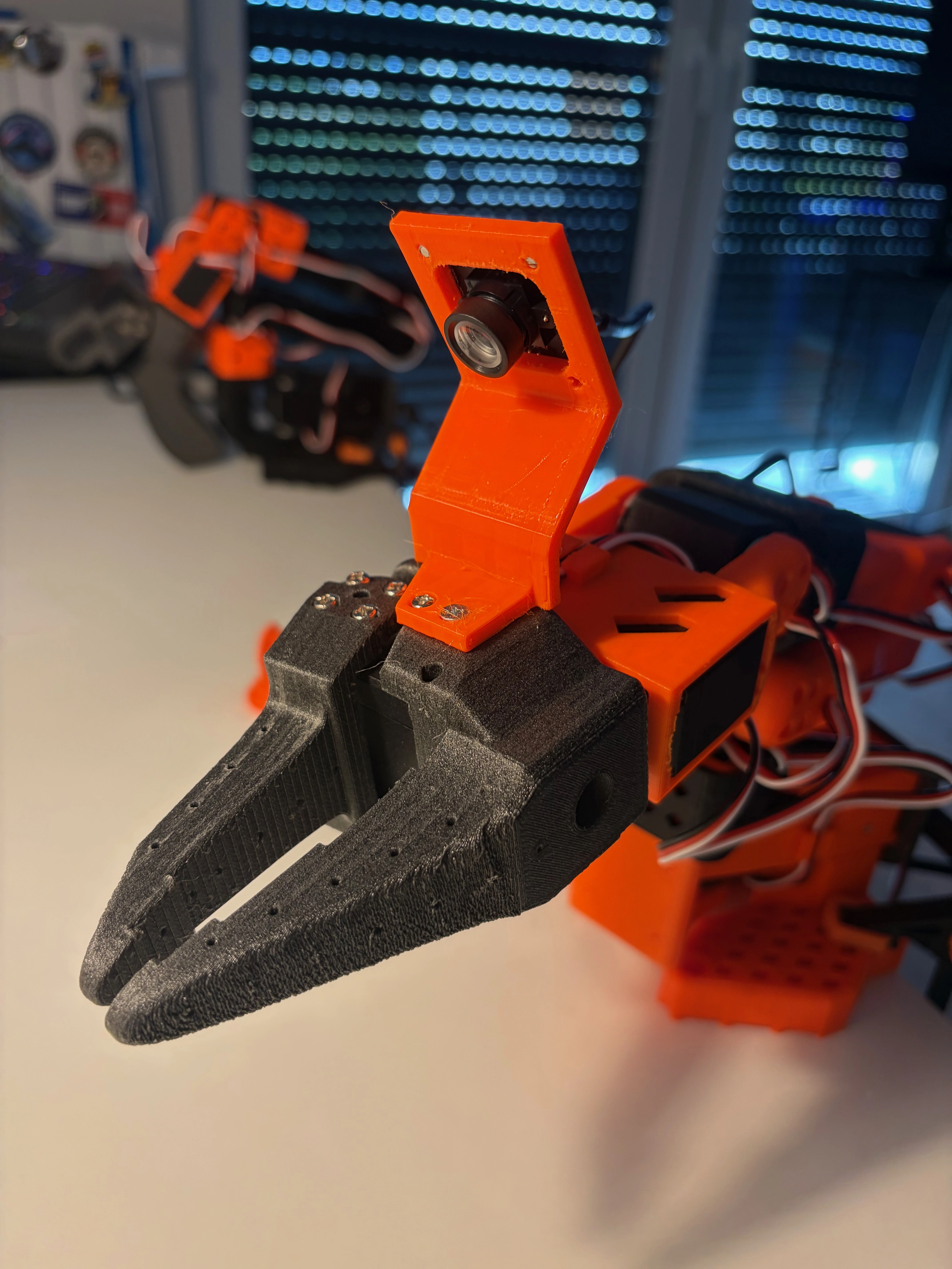 Merry, the leader robot arm, with a 3D-printed gripper and wrist camera